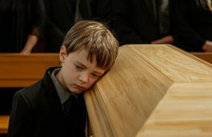 The Boy Rested His Ear Against His Mother’s Coffin And Spoke Words That Made Everyone In The Church Fall Silent.